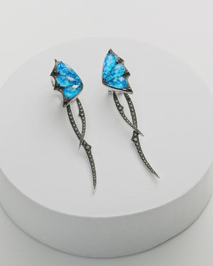 Fly By Night blue butterfly drop earrings in 18k white gold with black opalescent crystal haze and diamond pavé