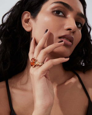 Model wearing Red Sail Sunset cocktail ring — yellow-gold ring with citrine, rubies and diamonds