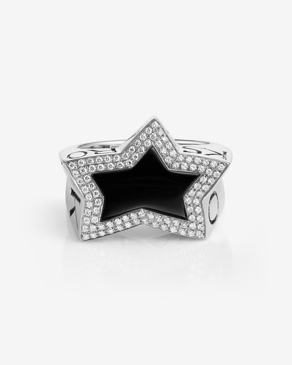 Flat-lay view of Stephen Webster star-shaped black onyx ring on neutral background — Sex & Drugs & Rock & Roll collection