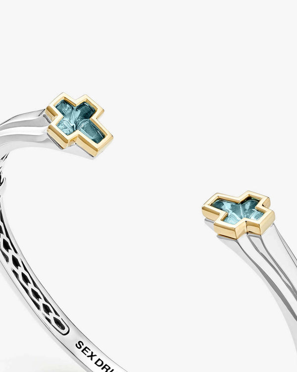 Close-up detail of blue-topaz ends and sterling-silver polished finish on Sex & Drugs & Rock & Roll bangle