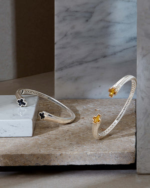 Rotated-angle view of Sex & Drugs & Rock & Roll bangle showing cuff thickness and citrine-tipped ends