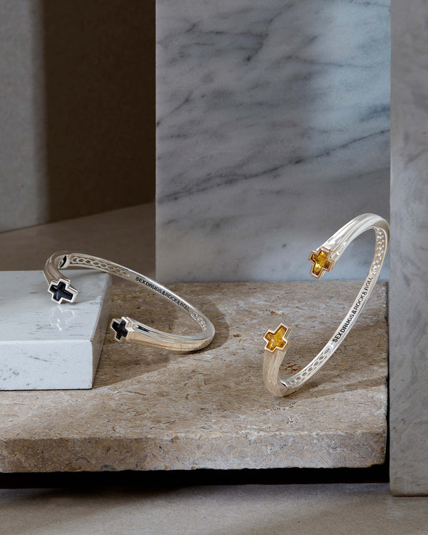 Rotated-angle view of Sex & Drugs & Rock & Roll bangle showing onyx ends and cuff curvature
