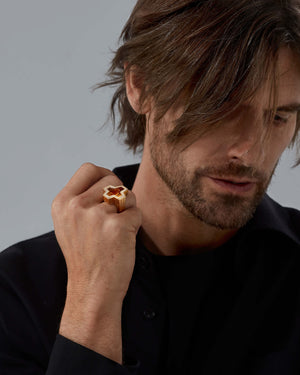 Side profile of Stephen Webster cross-shaped Sex & Drugs & Rock & Roll ring — 18 ct yellow-gold shank and citrine cross setting