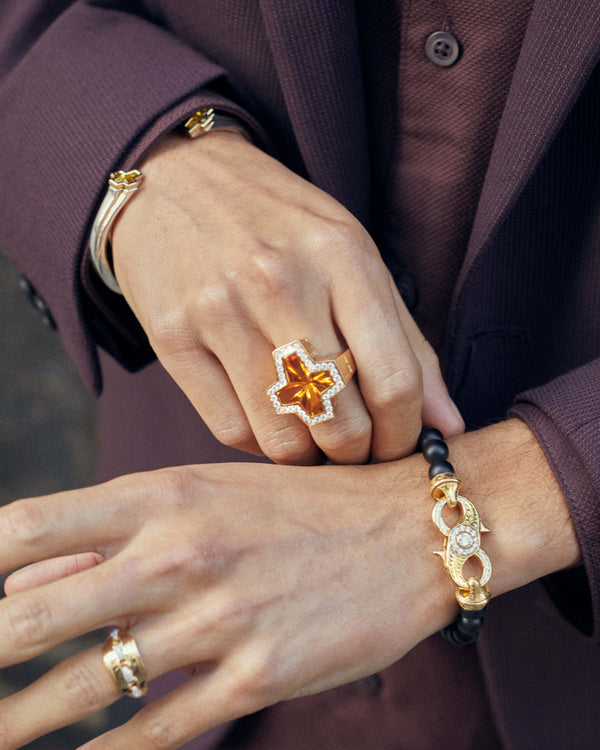 Styled view of Stephen Webster cross-shaped citrine ring showing gemstone cross and yellow-gold profile