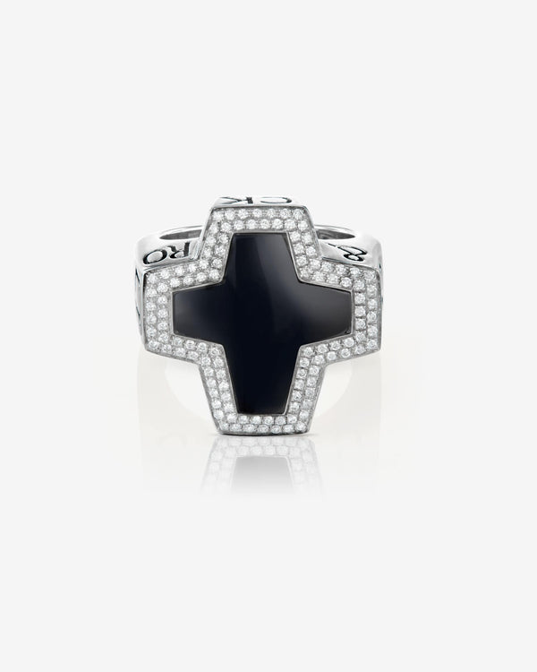 Flat-lay view of Stephen Webster cross-shaped black onyx ring on neutral background — Sex & Drugs & Rock & Roll collection
