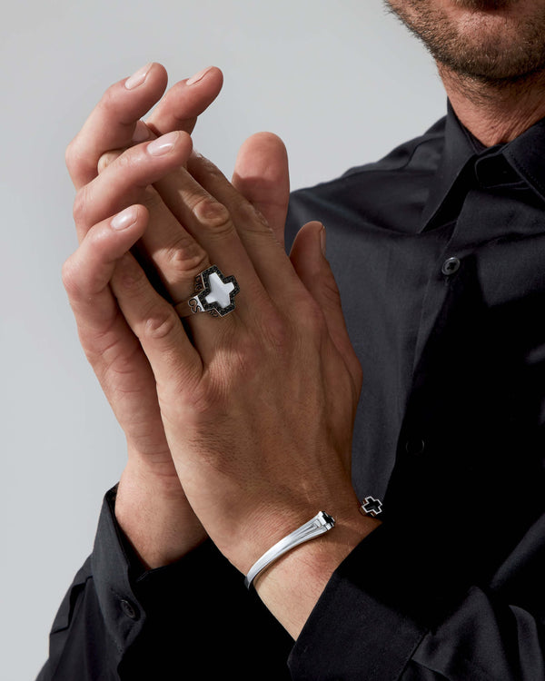 Model wearing Stephen Webster Sex & Drugs & Rock & Roll cross-shaped ring — silver ring with mother-of-pearl inlay