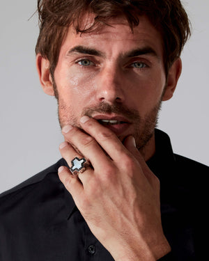 Side profile of Stephen Webster cross-shaped Sex & Drugs & Rock & Roll ring in silver with mother-of-pearl inlay