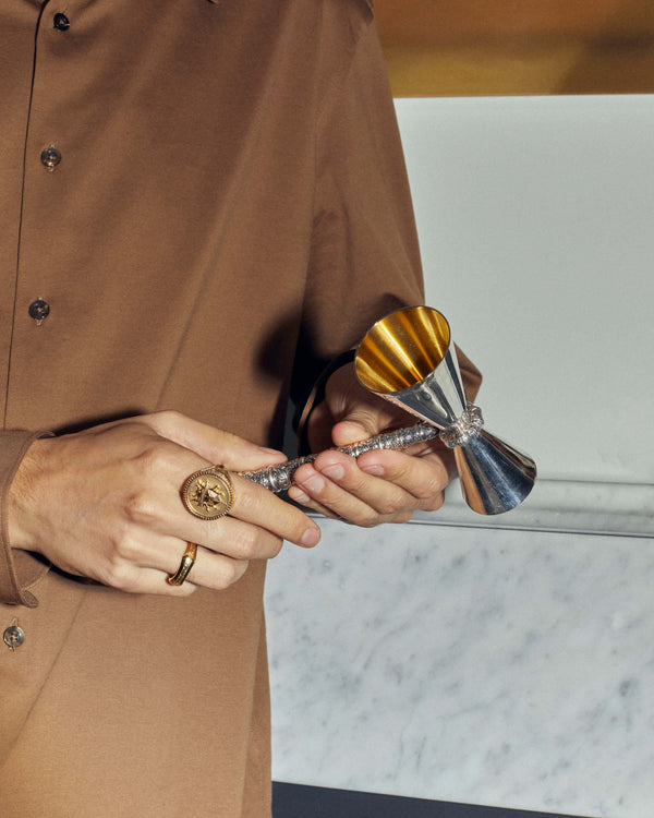 Silver Snake Measurer styled in a luxury barware setting