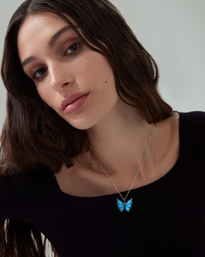 Model wearing Stephen Webster Black Opalescent Crystal Haze butterfly pendant — 18 ct white gold fine jewellery
