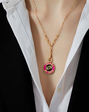 Close-up of Stephen Webster Bonus Track 18 ct gold pendant worn around model’s neck, showing enamel vinyl design and polished gold finish