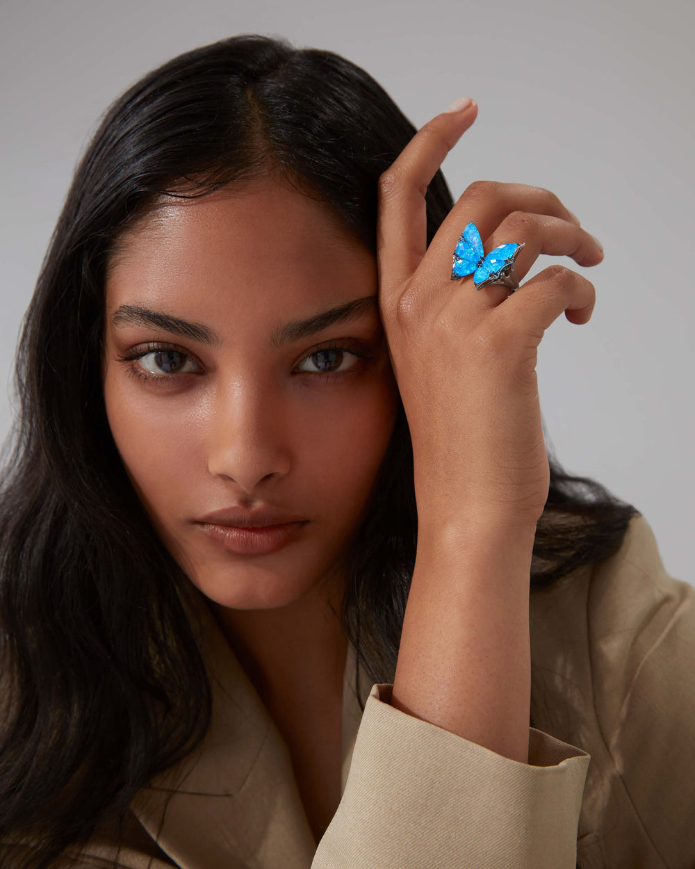 Side profile of Stephen Webster Crystal Haze butterfly cocktail ring — 18 ct white gold and faceted blue Crystal Haze quartz