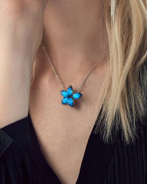 Close-up of model wearing Stephen Webster Crystal Haze Chance white gold pendant, accentuating gemstone luminosity against elegant neckline styling