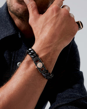 Close-up view of model’s wrist wearing black-ceramic Cuban bracelet — detailed view of ceramic link shine, texture and bracelet proportions