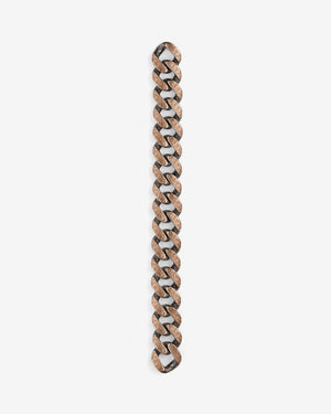 Stephen Webster Cuban bracelet in silver & yellow gold laid flat — full length showing engraved smoke-pattern links