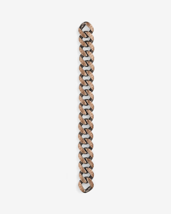Stephen Webster Cuban bracelet in silver & yellow gold laid flat — full length showing engraved smoke-pattern links