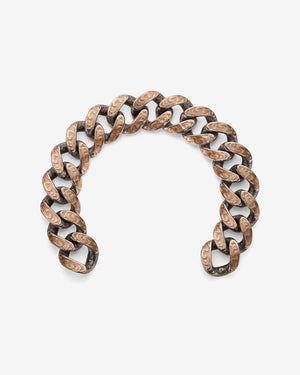 Stephen Webster Cuban bracelet in silver & rose gold laid flat — full length showing engraved smoke-pattern links