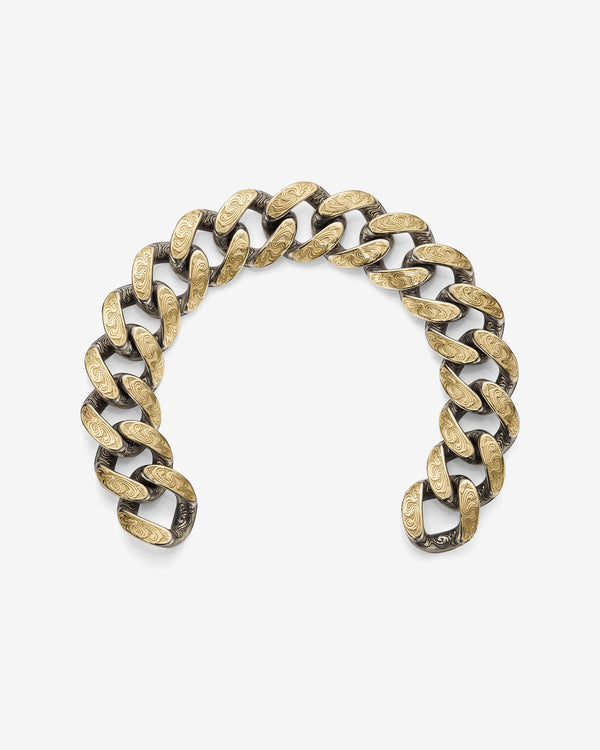 Stephen Webster Cuban bracelet in silver & yellow gold laid flat — full length showing engraved smoke-pattern links