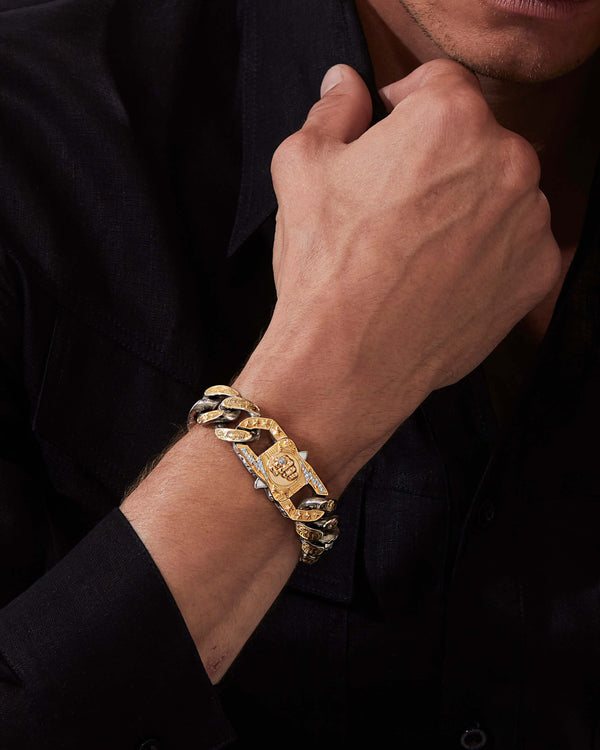 Model wearing Stephen Webster Cuban bracelet in silver & yellow gold with paired clasp — engraved smoke-pattern links and polished metal texture visible