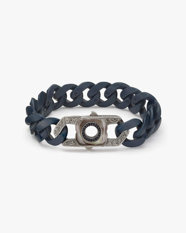 Angled view of Stephen Webster deep-blue matt ceramic bracelet — highlighting ceramic links, matte surface texture and bracelet shape