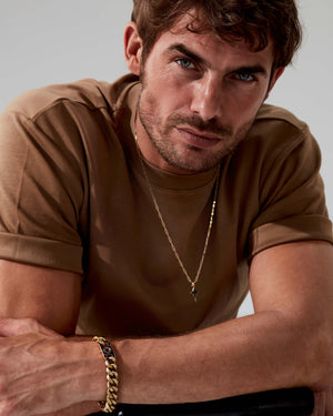 Styled shot of Cuban Leaf bracelet on model’s wrist with outfit — bracelet visible, highlighting design and finish in real-world context