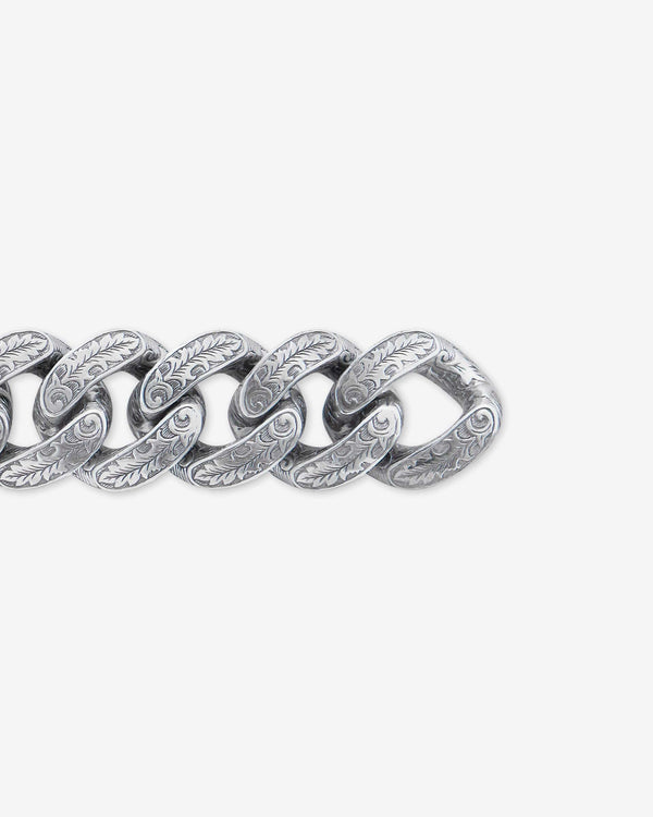 Close-up detail of Stephen Webster Cuban Leaf silver bracelet — engraved leaf-pattern links and polished metal texture visible