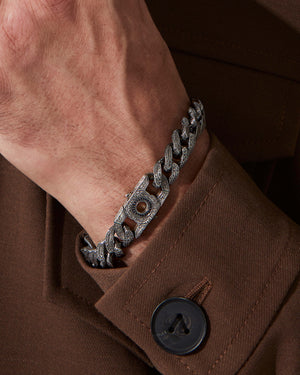 Close-up of model’s wrist wearing Cuban Leaf wide-link silver bracelet — detailed view of engraved links, silver finish and bracelet proportions under natural light