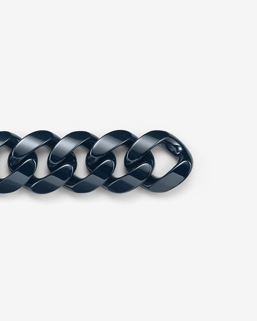 Close-up of Stephen Webster Cuban polished navy blue ceramic bracelet — detailed view of polished ceramic link surface and link joints