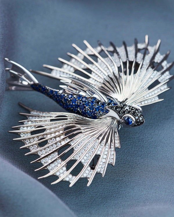Close-up of Stephen Webster Flying Fish brooch highlighting deep blue sapphires, brilliant black diamonds and precision craftsmanship in titanium and white gold