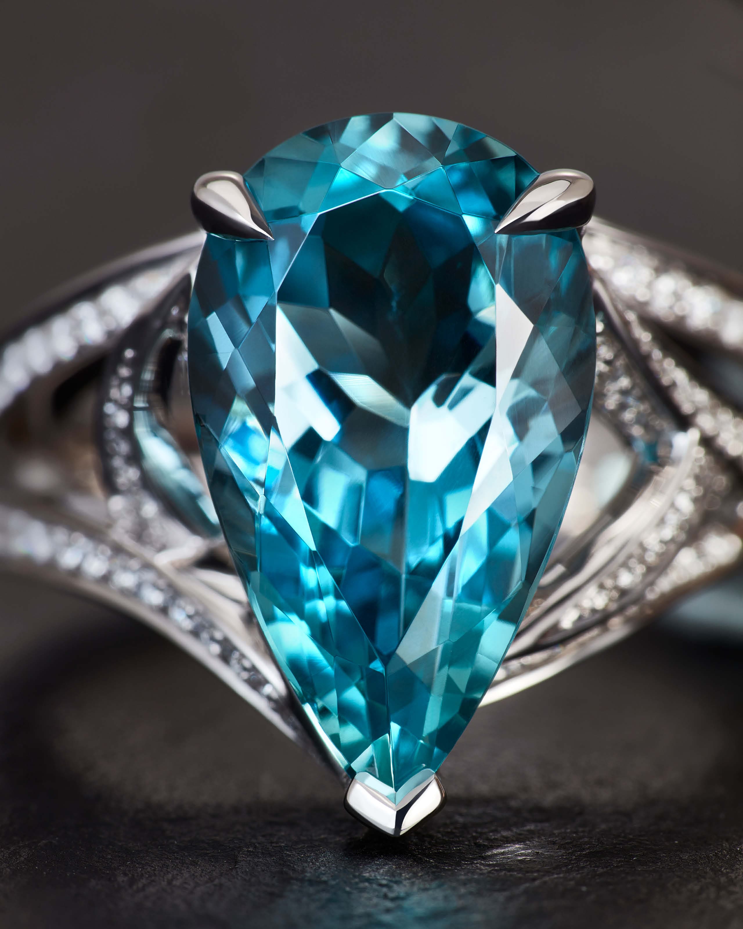 Aquamarine gemstone close-up showing metallic blue to blue-green hue sourced by Stephen Webster