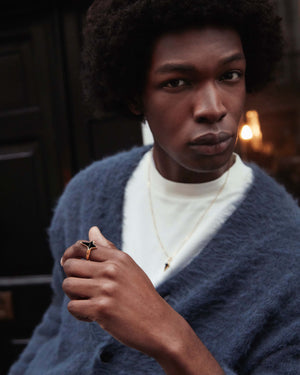 Model wearing Stephen Webster New Cross black onyx ring — showing ring fit, gold finish and onyx detail on finger