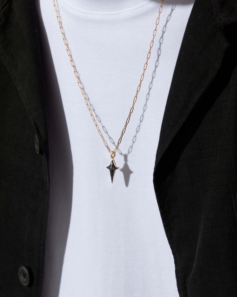 Stephen Webster New Cross pendant in 18 ct yellow gold with black diamond pavé on 24" chain — front view of cross pendant