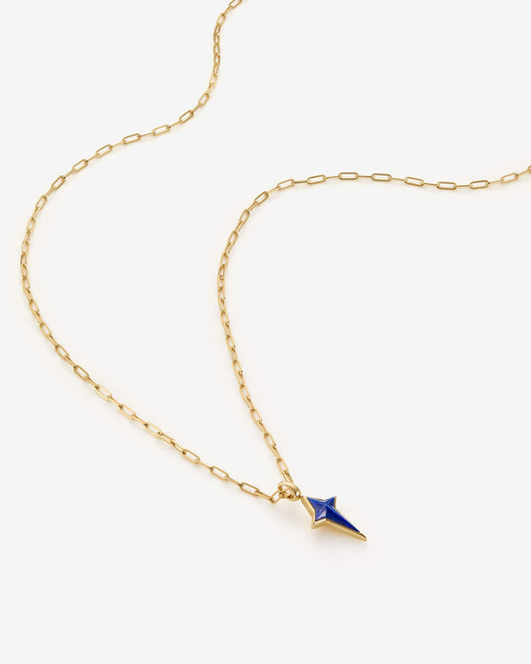 Side profile of Stephen Webster New Cross gold pendant with lapis inlay — showing pendant thickness, bail and chain detail