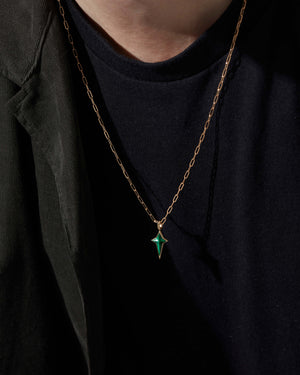 Model wearing Stephen Webster New Cross malachite pendant on gold chain — pendant visible on chest, highlighting size, drape and stone detail