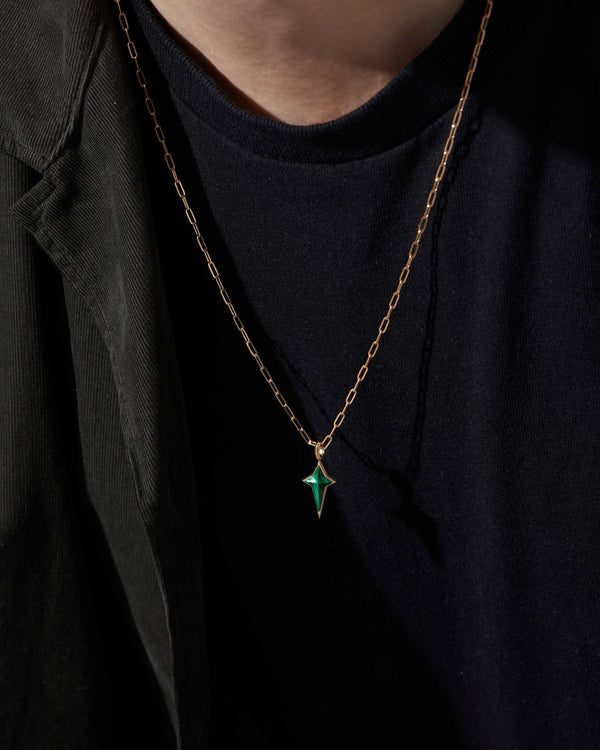 Model wearing Stephen Webster New Cross malachite pendant on gold chain — pendant visible on chest, highlighting size, drape and stone detail