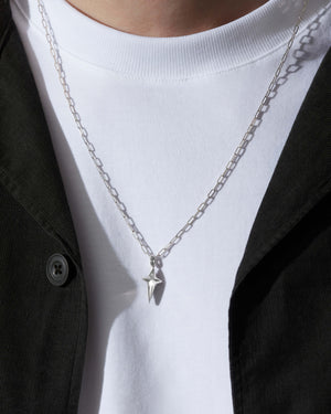 Model wearing Stephen Webster New Cross pendant on silver chain — pendant visible on neck