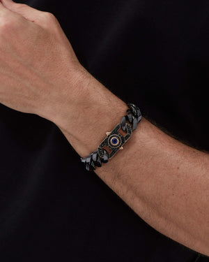 Model wearing Stephen Webster Revolutionary Clasp in 18 k rose gold with blue sapphire on Cuban bracelet