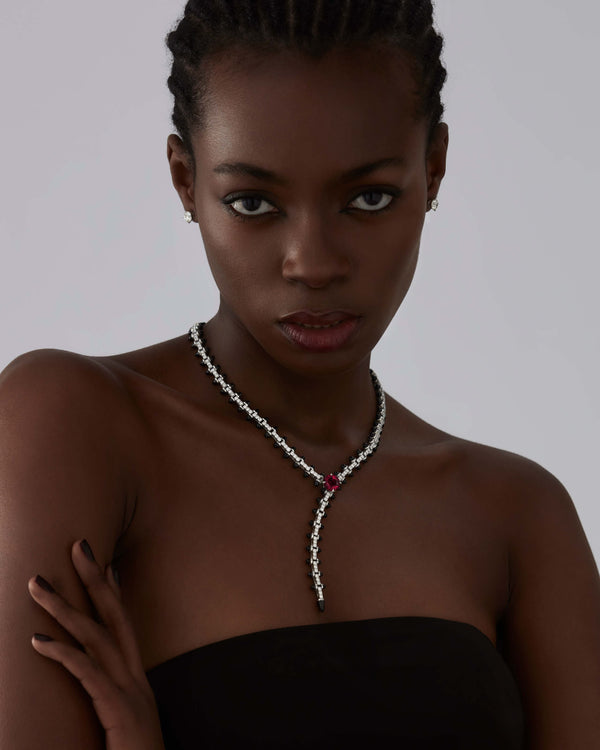 Model wearing the Stephen Webster Russian Roulette white gold collar necklace, showing scale, gemstone detail and statement luxury styling