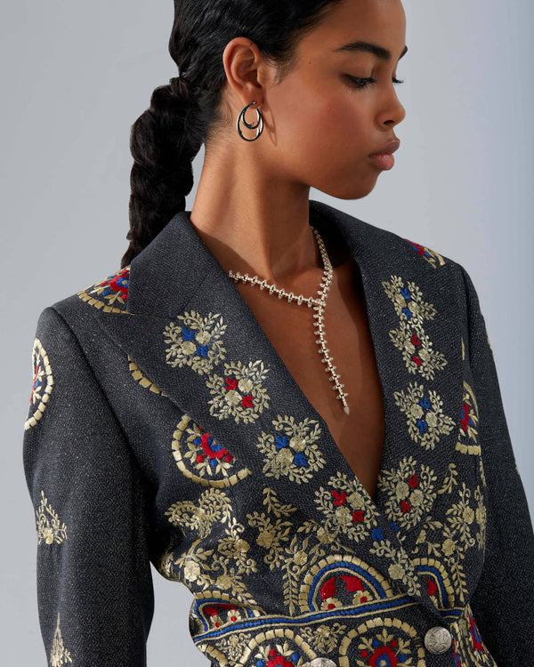 Stephen Webster Russian Roulette Magazine necklace worn as part of a styled look, highlighting its rebellious elegance and sculptural gold design