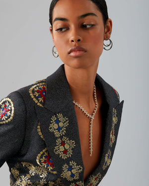 Stephen Webster Russian Roulette Magazine necklace worn as part of a styled look, highlighting its rebellious elegance and sculptural gold design