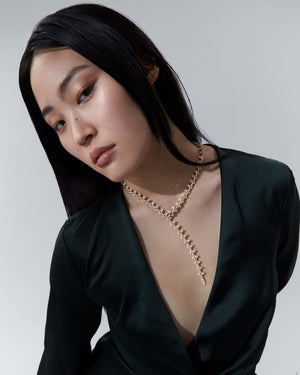 Model wearing the Stephen Webster Russian Roulette Magazine necklace, showing scale, neckline placement and bold luxury styling