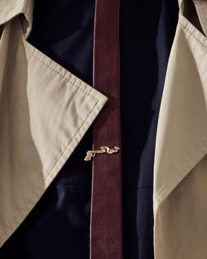 Close-up of tie with Smoking Gun gold tie clip — gold finish against fabric for styling context