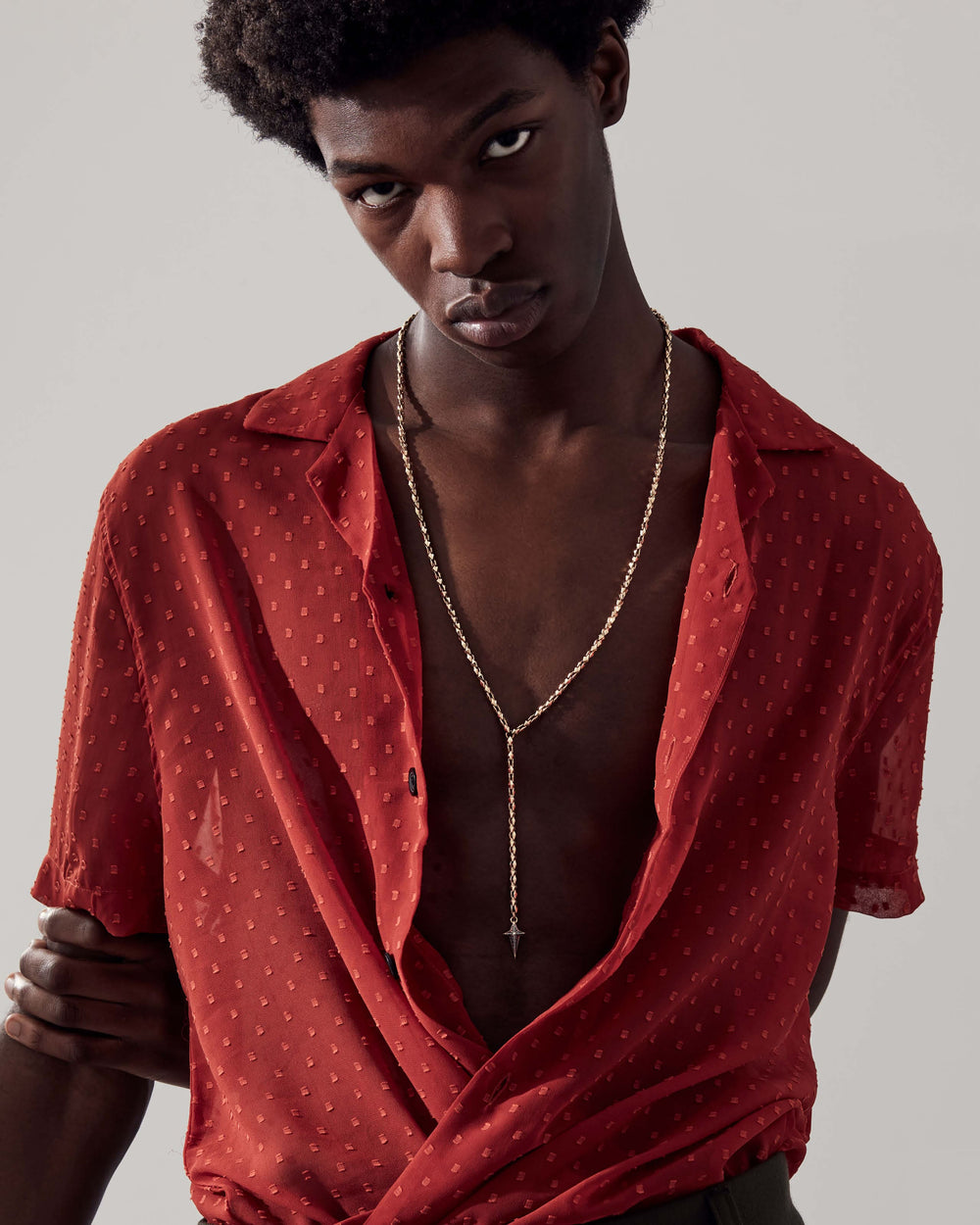 Stephen Webster Superstud New Cross gold chain necklace hanging — showing pendant drop and chain design with black diamond cross pendant