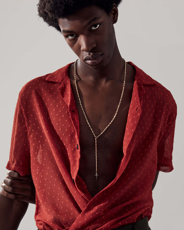 Model wearing Stephen Webster Superstud New Cross long chain necklace — showing how 32″ chain drapes and the pendant sits on chest