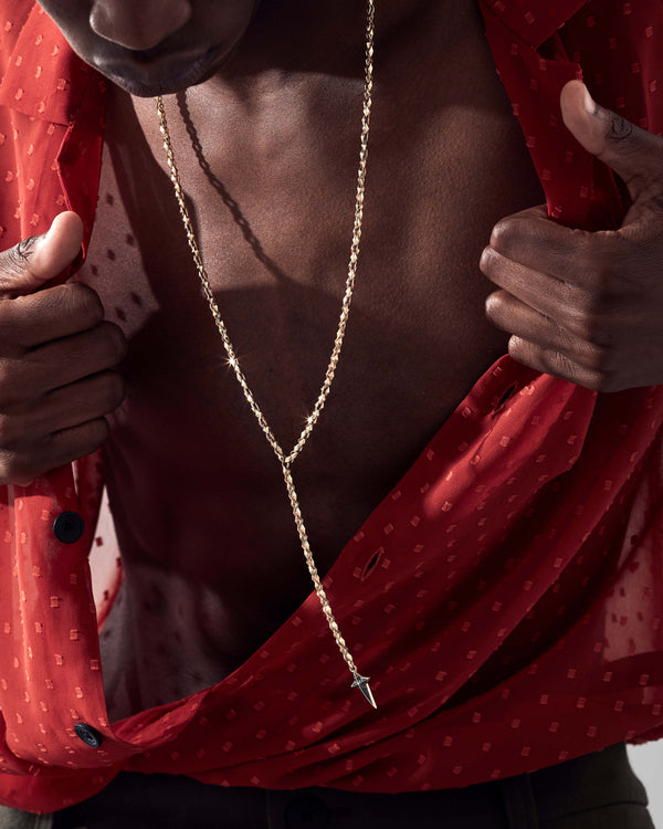 Model wearing Stephen Webster Superstud New Cross long chain necklace — showing how 32″ chain drapes and the pendant sits on chest