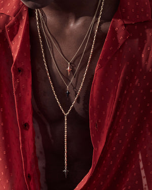 Model wearing Superstud long chain necklace styled with clothing and other necklaces — pendant visible to highlight design and chain length