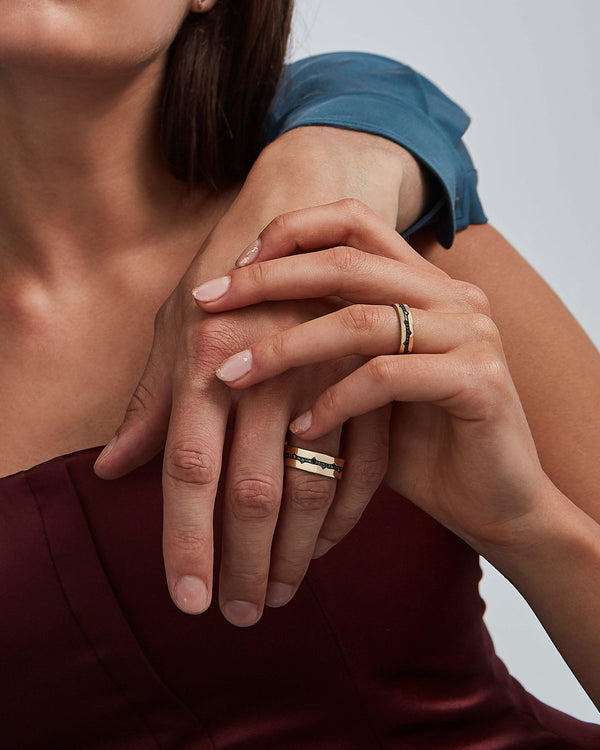 Model wearing Stephen Webster Thorn Fine Inscription Band in 18 k yellow gold with black diamond pavé