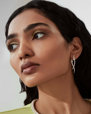 Stephen Webster Stem Drop Earrings in 18ct White Gold with white diamond pavé worn on model close up