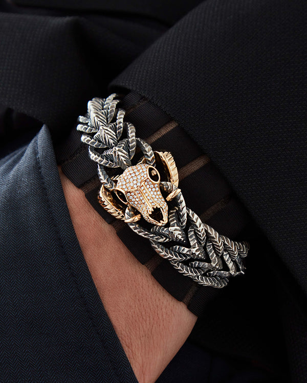 Close-up of model’s wrist wearing Rams Head bracelet — detailed view of ram-head skull, link design, and polished gold finish