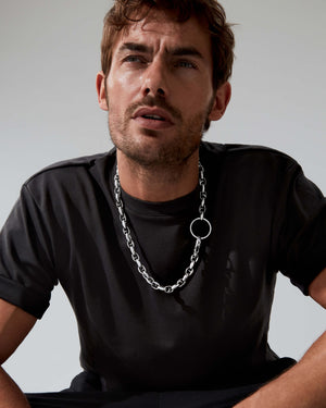 Styled close-up of Stephen Webster Thorn Barbed Chain on a model showing how it pairs with menswear