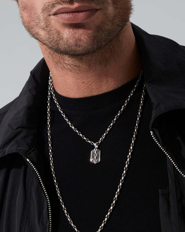Styled close-up of Stephen Webster Thorn Medium Razer Tag necklace on model’s neck showing pendant and chain
